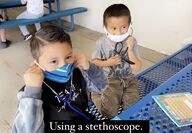 students learning how to use stethoscopes