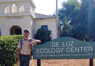 Boy leaning on sign for Ecology Center