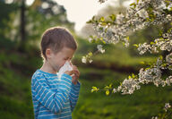 child blowing nose